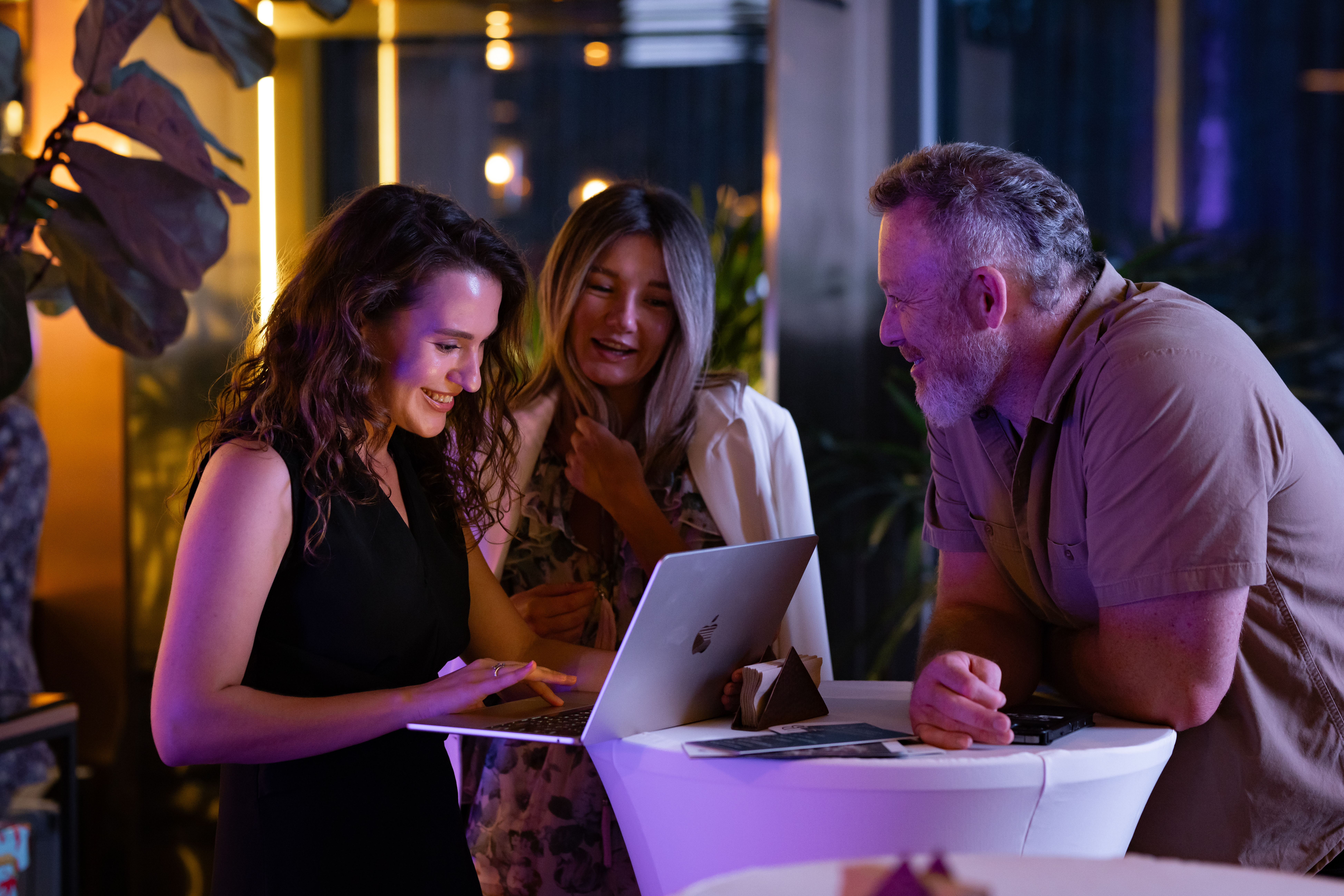 Corporate networking guests using a laptop at a business event in Phuket